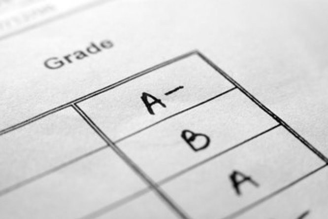 Report card listing grades on a paper