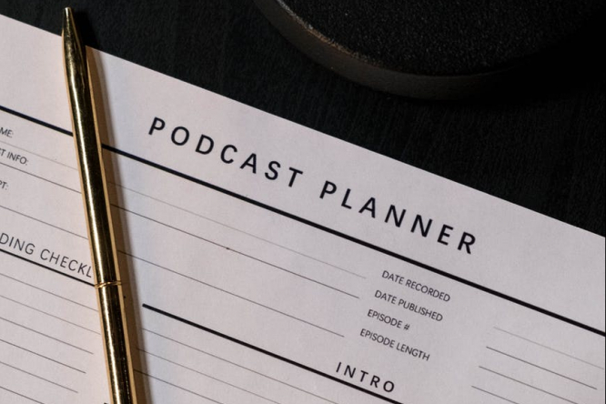 Podcast planning document template with a pen